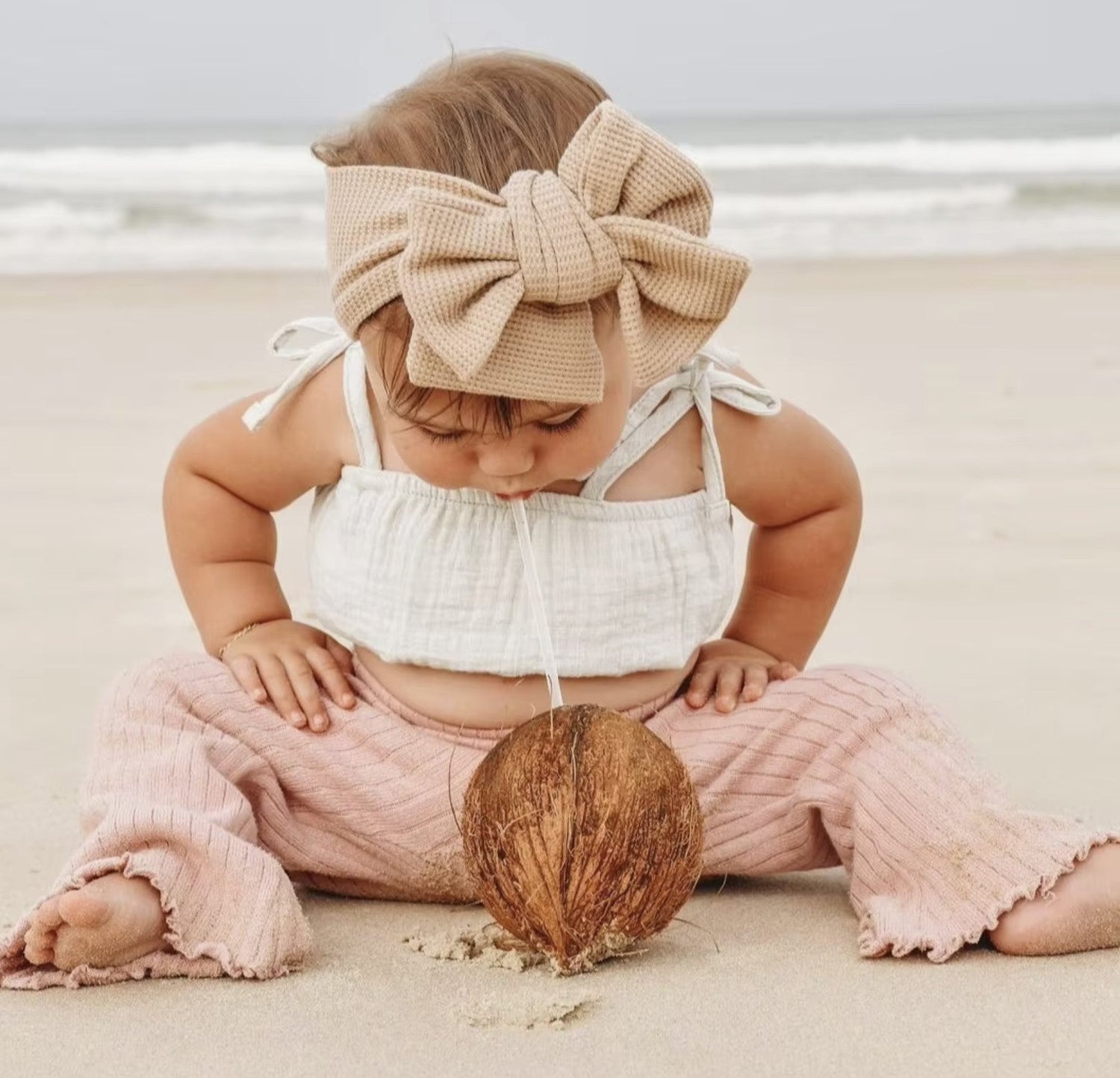 A baby with a very charming and adorable hair accessory from Haile Cozzie Soles