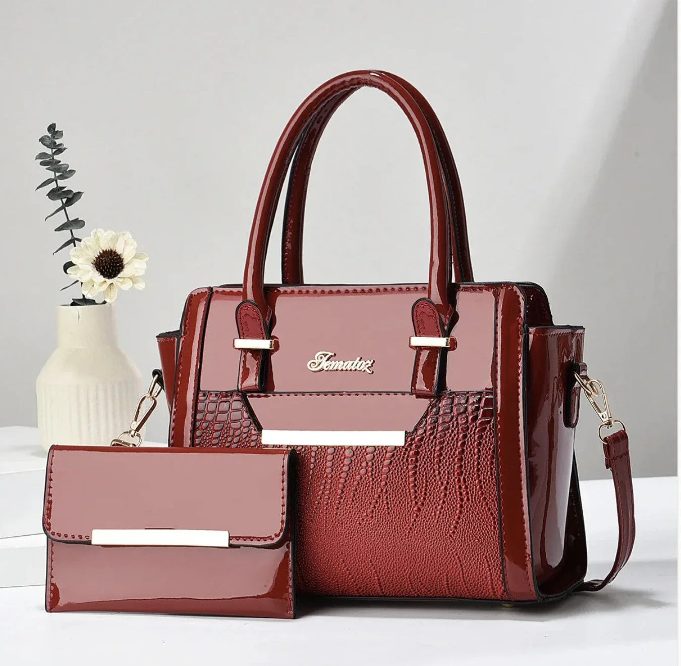 An elegant ladies handbag with a purse in marooncolor